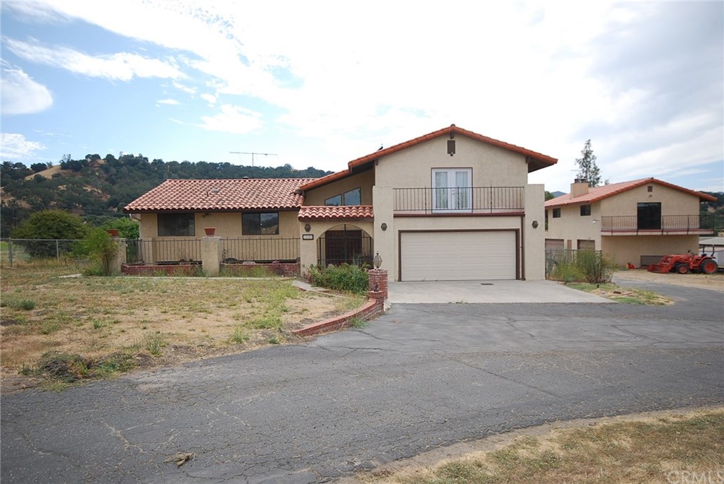 Spacious home plus county permitted studios! Main home is 2312 sqft with 4 bedrooms/3 baths. Second building on right offers 2 apartments over garage/workshop.