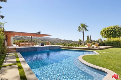 a view of a swimming pool and lake from a balcony