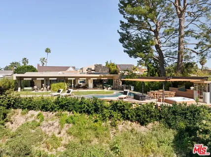 a view of a house with wooden fence