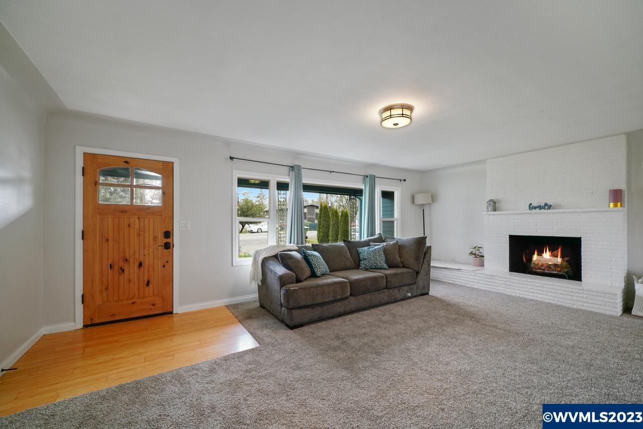 3039 Pringle Road Southeast Salem, OR 97302 - Photo 6 of 29 a living room with furniture and a fireplace
