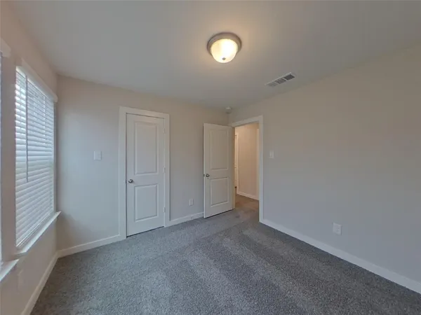 a view of an empty room and a window
