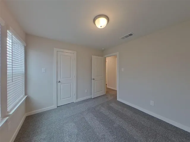 a view of an empty room and a window