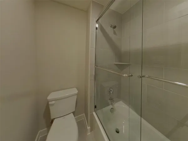 a bathroom with a toilet and shower