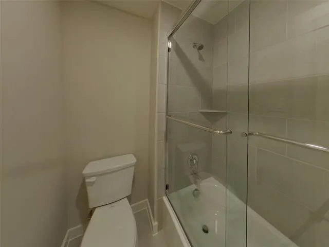 a bathroom with a toilet and shower
