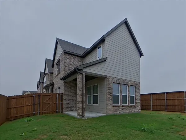 a view of a house with a yard and sitting area