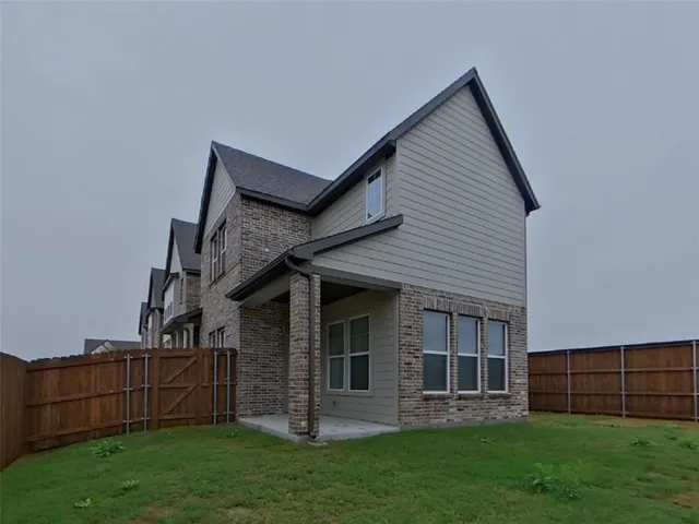 a view of a house with a yard and sitting area