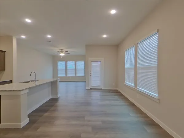 a view of a kitchen with a sink and a large window