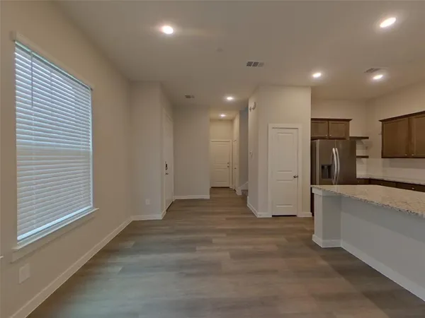 a view of a kitchen with a sink and a refrigerator