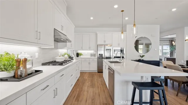 a large kitchen with a table and chairs in it