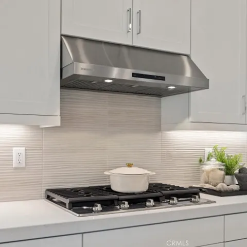 a stove top oven sitting inside of a kitchen