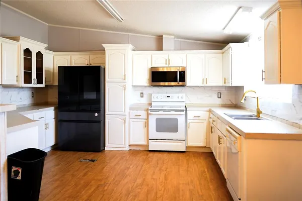 a kitchen with a sink a stove and refrigerator