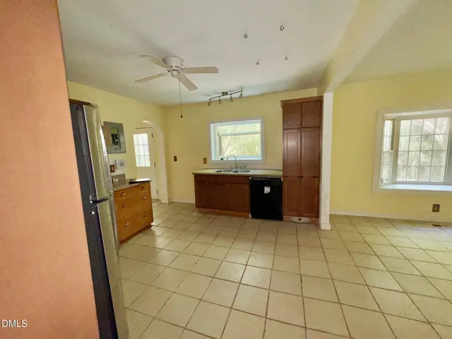 a kitchen with granite countertop a refrigerator and a sink