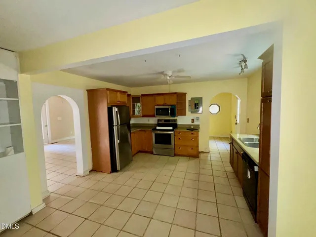 a kitchen with stainless steel appliances granite countertop a refrigerator and a sink