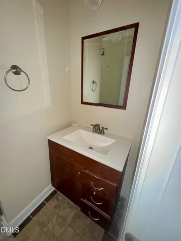 a bathroom with a sink vanity and mirror