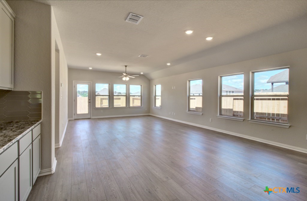 2118 Shepard Street Seguin, TX 78155 - Photo 17 of 24 a view of an empty room with wooden floor and a window