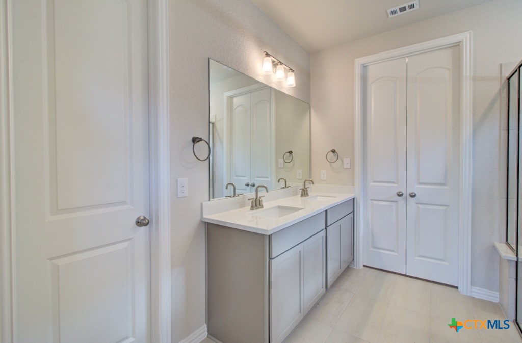 2118 Shepard Street Seguin, TX 78155 - Photo 22 of 24 a bathroom with a sink and a mirror