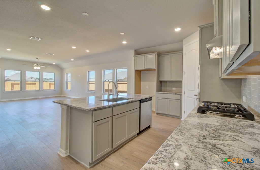 2118 Shepard Street Seguin, TX 78155 - Photo 3 of 24 a kitchen with a sink stove and cabinets