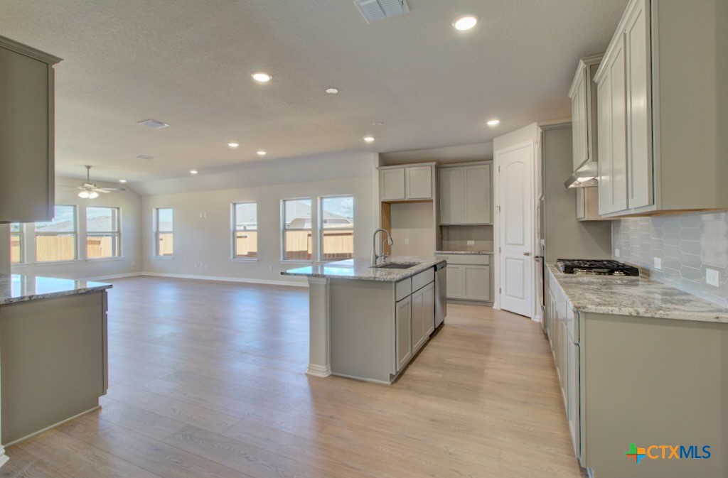 2118 Shepard Street Seguin, TX 78155 - Photo 6 of 24 a large kitchen with stainless steel appliances granite countertop a large counter top a stove and a refrigerator