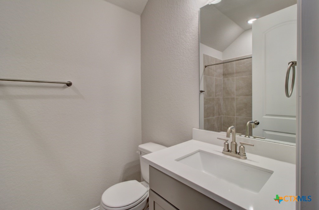 2118 Shepard Street Seguin, TX 78155 - Photo 10 of 24 a bathroom with a sink toilet and vanity