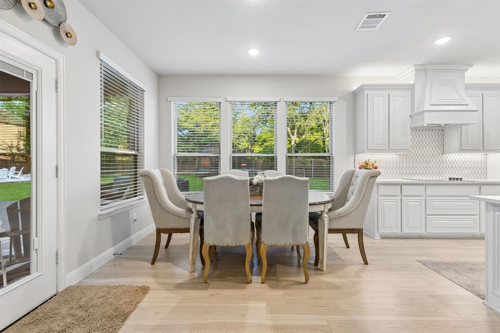 1023 Ridgehurst Road Melissa, TX 75454 - Photo 16 of 39 Dining area featuring wood-finish flooring, recessed lighting, and a set of three windows