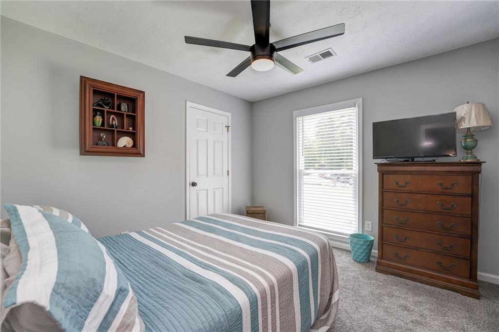 41 Summit Ridge Drive Southeast Cartersville, GA 30120 - Photo 13 of 43 a bedroom with a bed and a television