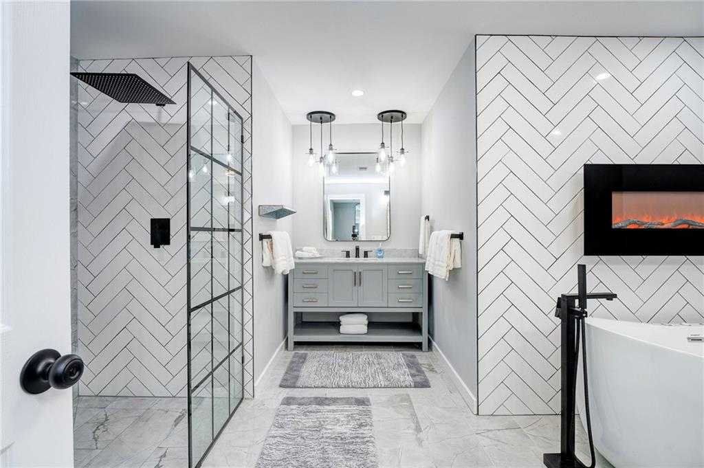 41 Summit Ridge Drive Southeast Cartersville, GA 30120 - Photo 17 of 43 a bathroom with a sink a mirror and shower