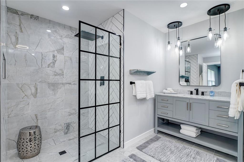41 Summit Ridge Drive Southeast Cartersville, GA 30120 - Photo 20 of 43 a bathroom with a double vanity sink a mirror and shower