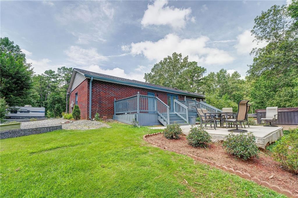 41 Summit Ridge Drive Southeast Cartersville, GA 30120 - Photo 21 of 43 a backyard of a house with table and chairs plants and large tree