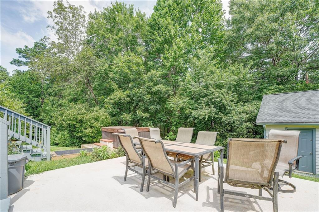 41 Summit Ridge Drive Southeast Cartersville, GA 30120 - Photo 23 of 43 a patio with table and chairs and potted plants with wooden floor and fence