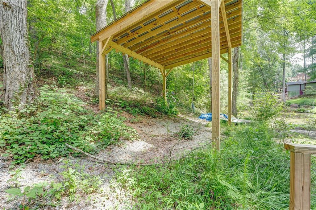 41 Summit Ridge Drive Southeast Cartersville, GA 30120 - Photo 36 of 43 a view of a backyard with plants and large trees