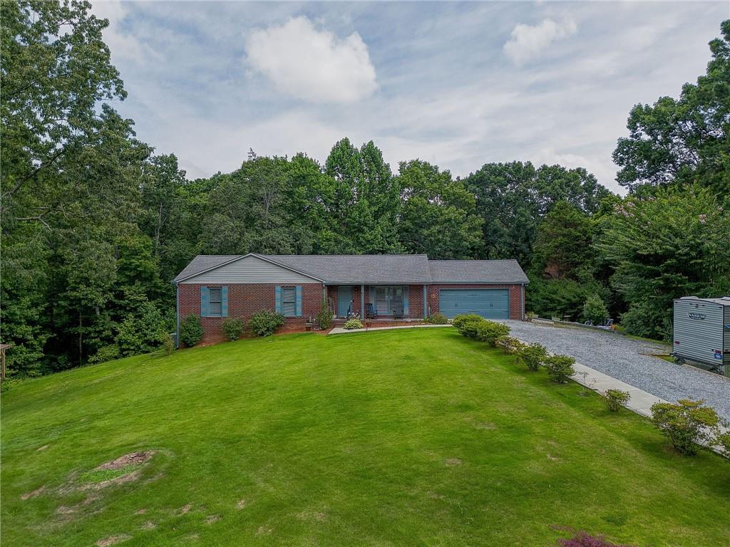41 Summit Ridge Drive Southeast Cartersville, GA 30120 - Photo 42 of 43 a view of an house with backyard space and garden