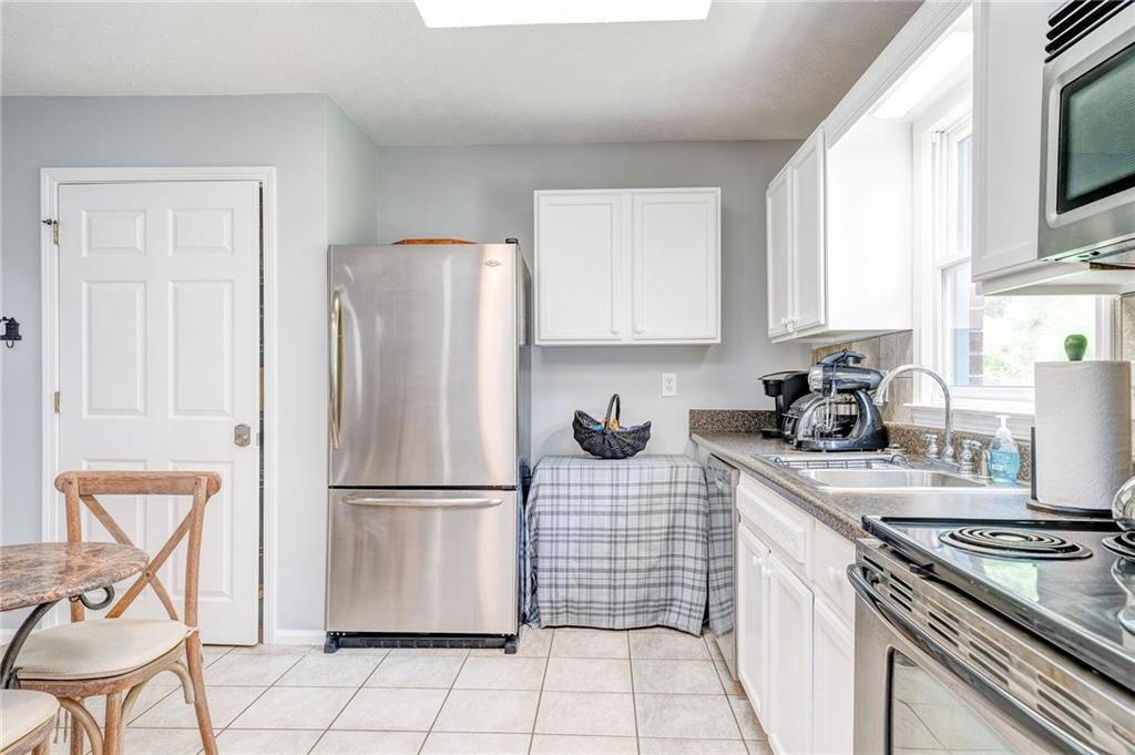 41 Summit Ridge Drive Southeast Cartersville, GA 30120 - Photo 8 of 43 a kitchen with a refrigerator a stove a sink and cabinets