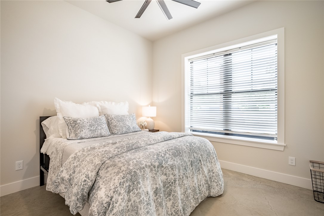6876 Koppe Bridge Road College Station, TX 77845 - Photo 14 of 23 a bedroom with a bed and a window