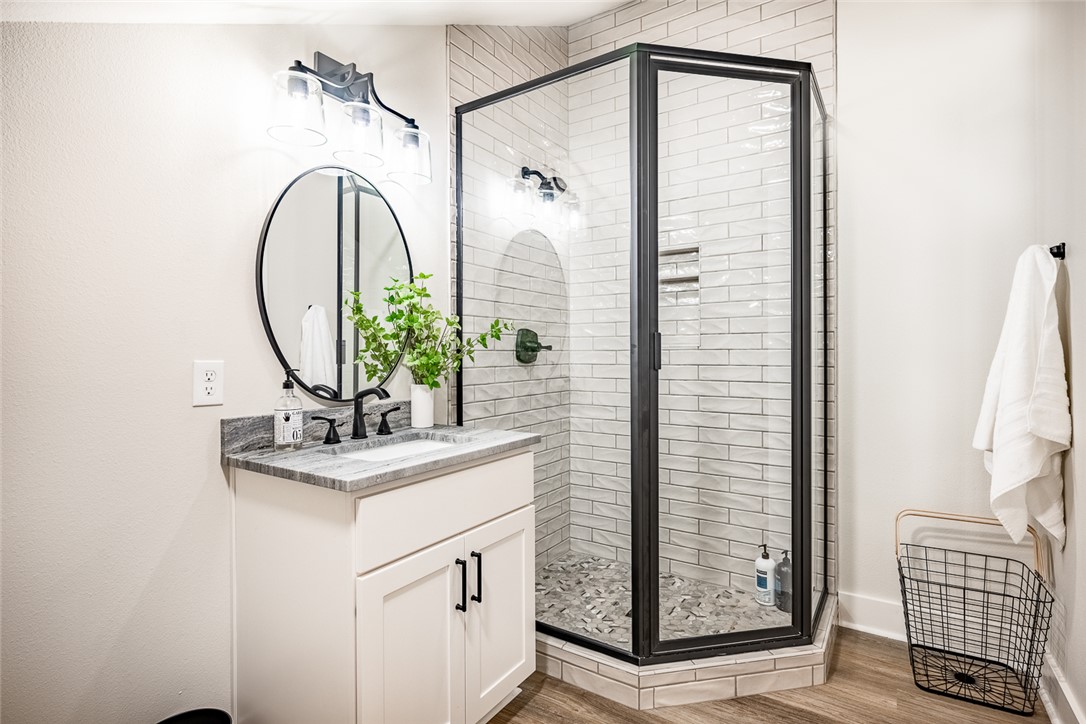 6876 Koppe Bridge Road College Station, TX 77845 - Photo 18 of 23 a bathroom with a sink a mirror and shower