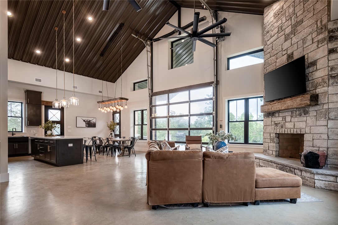 6876 Koppe Bridge Road College Station, TX 77845 - Photo 2 of 23 a living room with furniture a fireplace and a flat screen tv