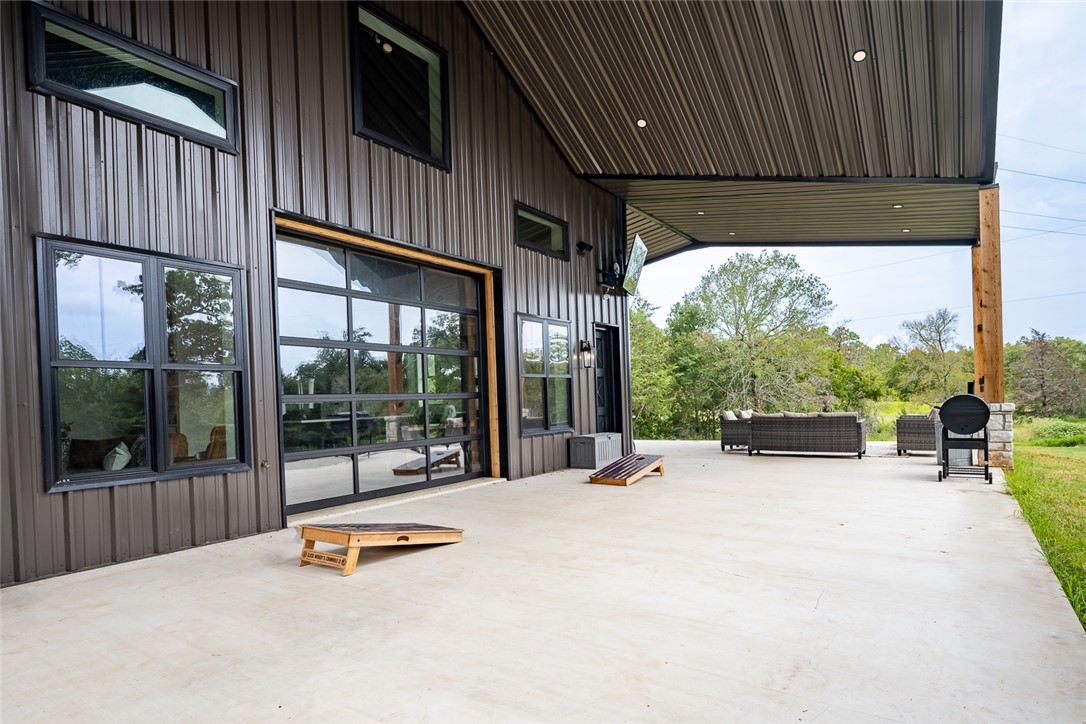 6876 Koppe Bridge Road College Station, TX 77845 - Photo 22 of 23 a view of a patio with a table and chairs next to a yard