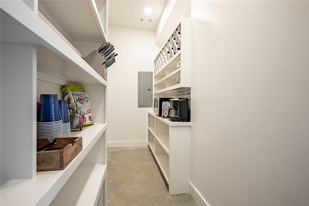 6876 Koppe Bridge Road College Station, TX 77845 - Photo 10 of 23 a hallway with a white cabinets and potted plant