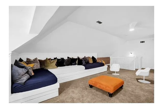 a living room with furniture rug and lamp