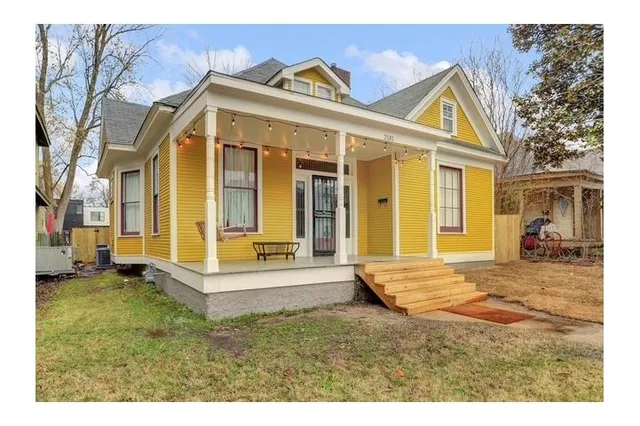 a view of a house with a tub and a yard