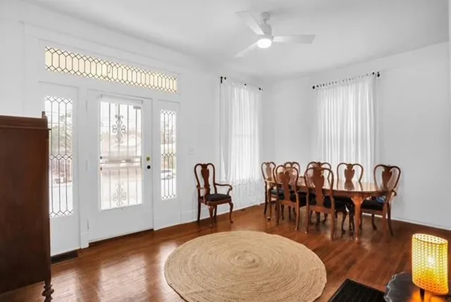 a view of a a dining room with furniture window and wooden floor