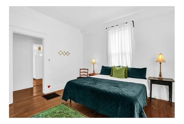 a bedroom with a bed and a window