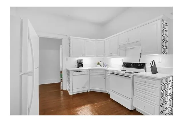 a kitchen with cabinets appliances and a sink