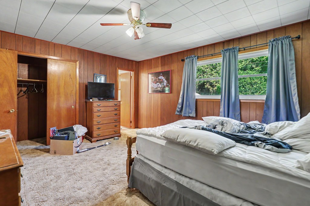 63 Fort Butler Street Murphy, NC 28906 - Photo 19 of 30 a bedroom with a large bed and a chandelier