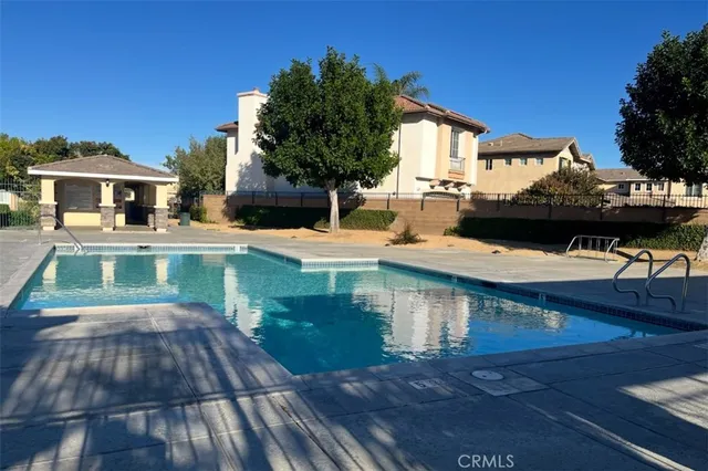 a view of a house with backyard and sitting area