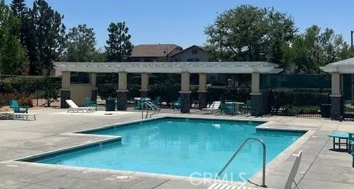 a view of a house with swimming pool and sitting area