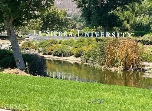 a view of swimming pool with a yard and plants