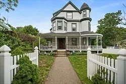 a front view of a house with a yard table and chairs