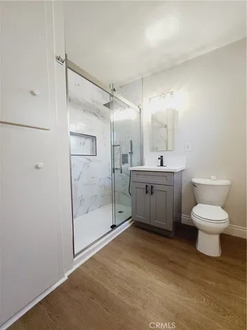 a bathroom with a toilet sink and shower