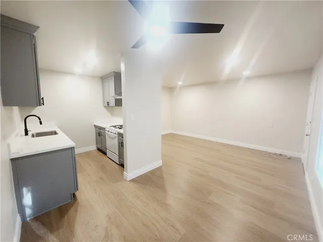 a view of a kitchen with sink and natural light