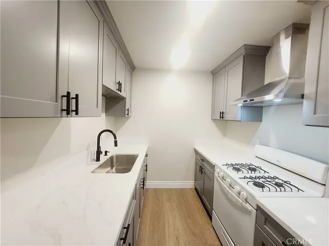 a kitchen with stainless steel appliances a sink a stove and a refrigerator